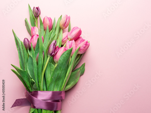 Bouquet pink tulips on lightpink background. © volff