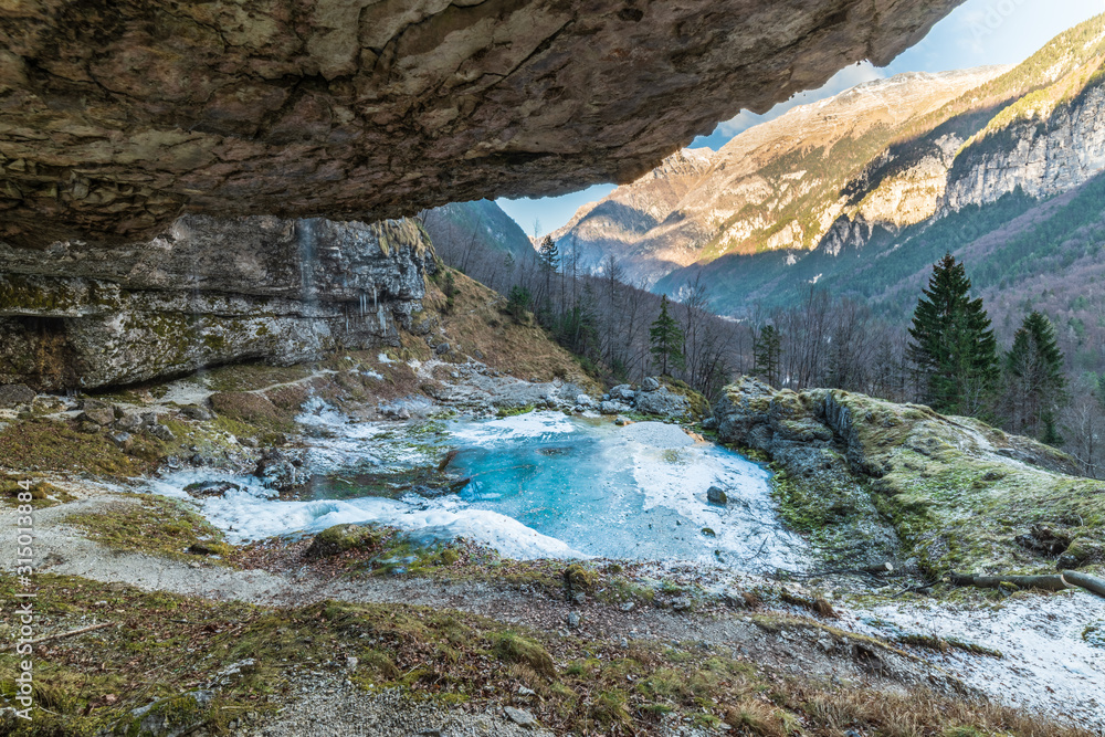 Winter. Ice games in the Fontanon of Goriuda waterfall. Friuli, Italy.