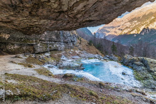 Winter. Ice games in the Fontanon of Goriuda waterfall. Friuli, Italy.