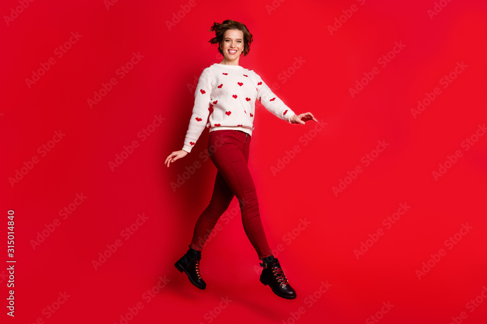 Full length body size view of nice attractive lovely pretty charming cheerful cheery glad girl having fun jumping strolling spending weekend isolated on bright vivid shine vibrant red color background Full length body size view of nice attractive lovely pretty charming cheerful cheery glad girl having fun jumping strolling spending weekend isolated on bright vivid shine vibrant red color background