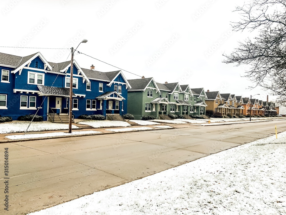 line of townhouses in winter snow