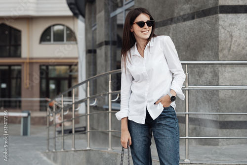 Portrait of One Fashionable Girl Dressed in Jeans and White Shirt, Business Lady, Woman Power Concept