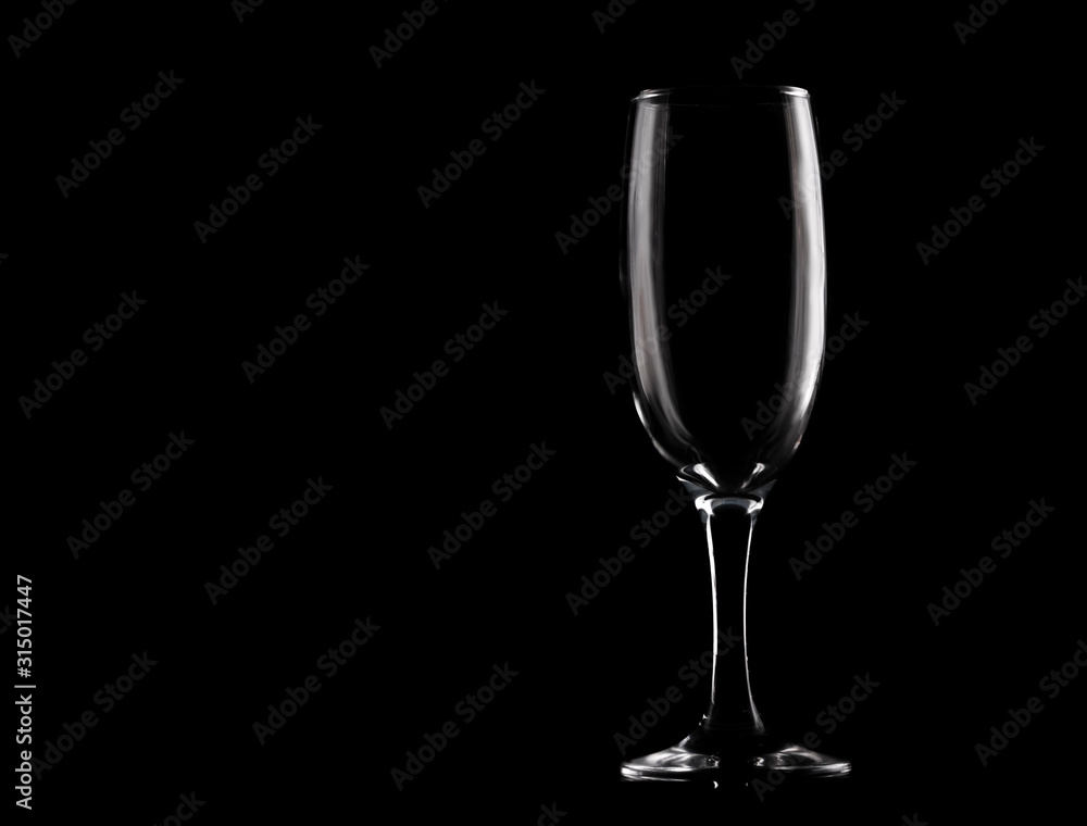 Empty wine glass on black background with copy space