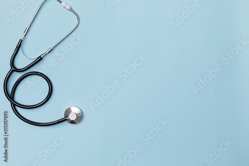 Creative flatlay of doctor medical equipment blue table with stethoscope, Health care concept, Top view with copy space, Isolated on blue photo