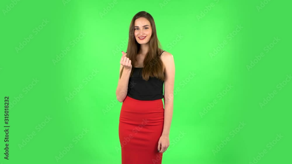 Cute girl smiles and showing heart with fingers then blowing kiss. Green screen Cute girl smiles and showing heart with fingers then blowing kiss. Green screen
