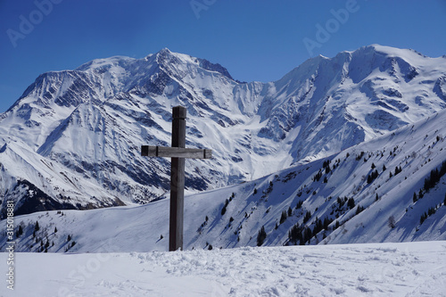 old wood cross at the top of the ski slopes of a French ski resort in the Alps