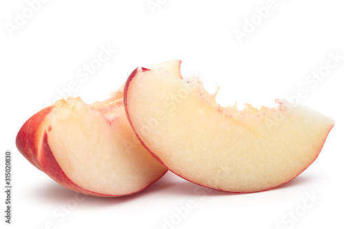 Fresh peach fruit sliced in pieces isolated on white with clipping path.