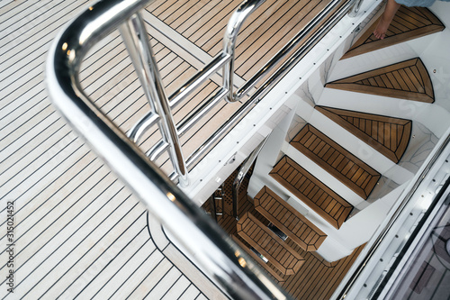 luxury yacht exterior: Wooden deck and steps flooring.