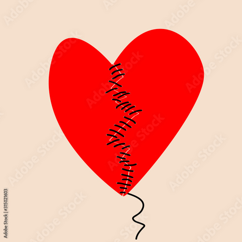 Fixing a broken heart concept with two halves of heart sewed with black thread