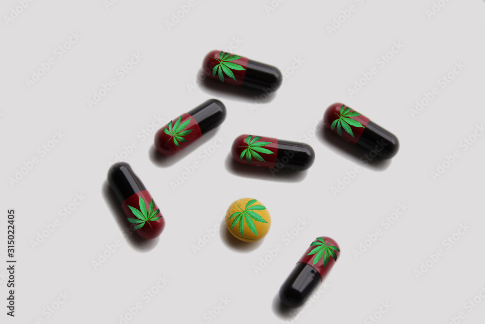 colored drugs, white pills, capsules with marijuana leaf icon on a white background, medical cannabis concept, top view, close-up, copy space colored drugs, white pills, capsules with marijuana leaf icon on a white background, medical cannabis concept, top view, close-up, copy space