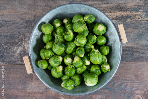 fresh raw brussels sprouts on wooden table