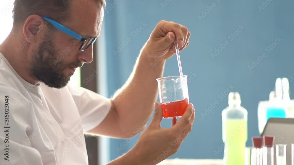 Man scientist doing lab test with chemicals Man scientist doing lab test with chemicals