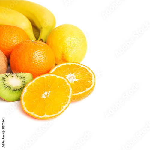 Group of tropical fruits, sliced halves of orange and kiwi isolated on white background