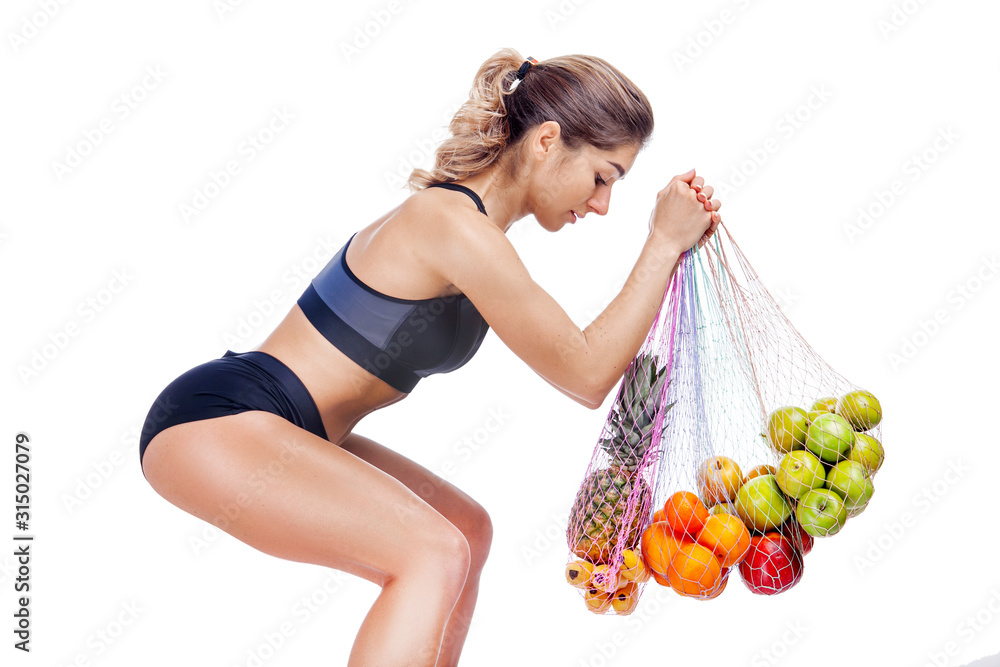 woman athlete on a white background with fruits woman athlete on a white background with fruits