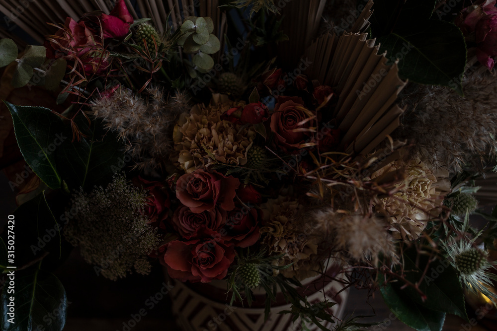 Obraz premium Detail view of a flower arrangement. Still life with roses in a ceramic vase.
