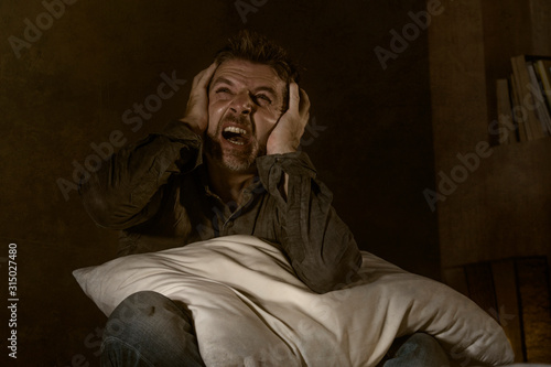 dramatic portrait of depressed and sick man suffering from psychosis illness or mental disorder looking weird and helpless in psychiatric and psychological problem concept