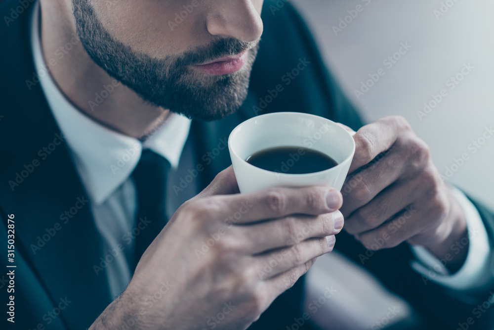 Cropped photo of successful business guy hold hands coffee beverage mug enjoy pleasant smell wear black blazer shirt tie suit costume sitting chair office indoors Cropped photo of successful business guy hold hands coffee beverage mug enjoy pleasant smell wear black blazer shirt tie suit costume sitting chair office indoors