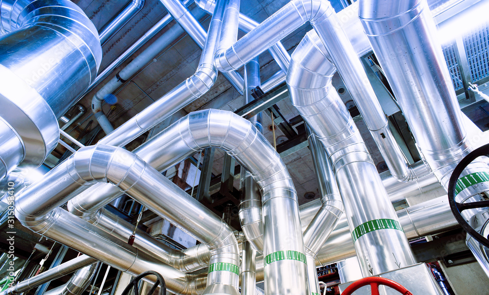 Equipment, cables and piping as found inside of a modern industrial power plant Equipment, cables and piping as found inside of a modern industrial power plant