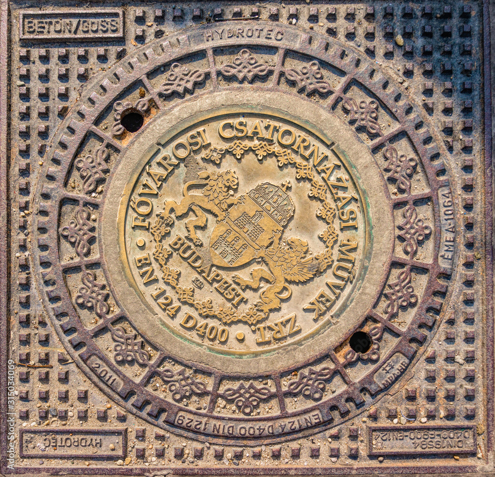 Old sewer manhole on a street in Budapest, Hungary	