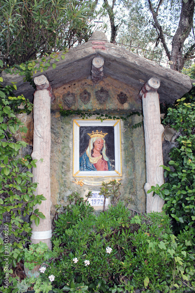 Cappella ex voto con fiori e piante dedicata alla Madonna