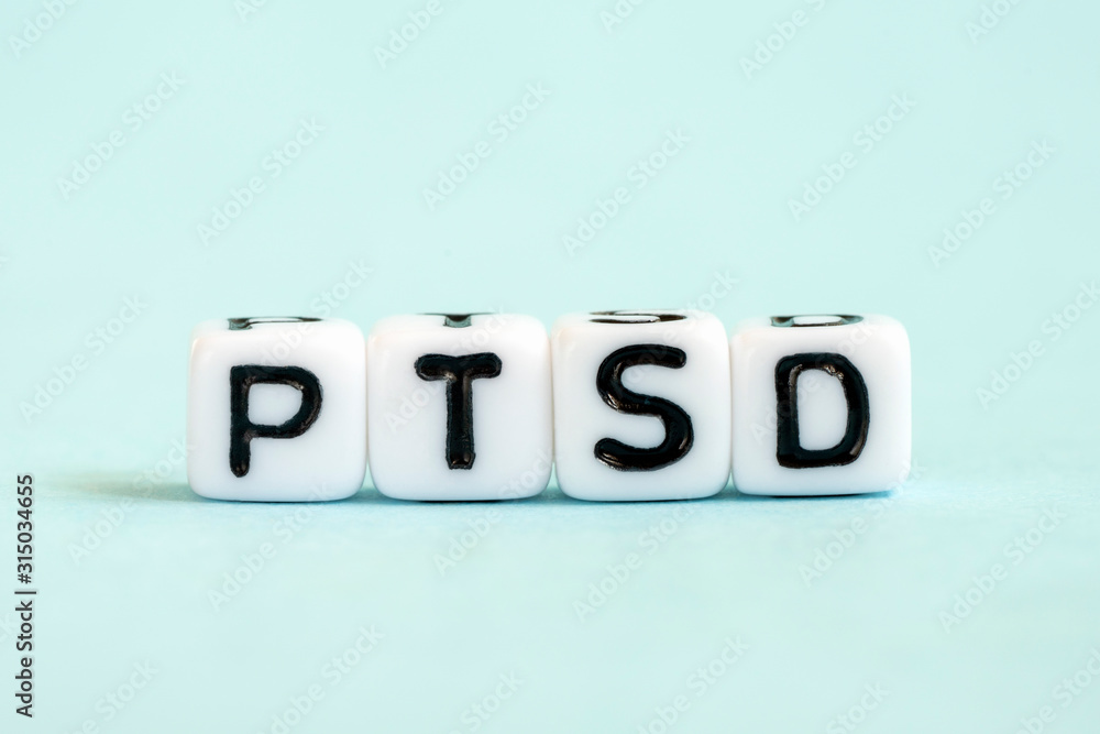 PTSD word written on blocks. Posttraumatic stress disorder inscription on blue background. Medical concept PTSD word written on blocks. Posttraumatic stress disorder inscription on blue background. Medical concept
