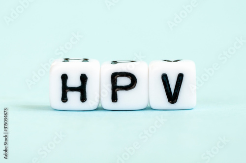 HPV - Human papillomavirus, word written on blocks. Humani Papilloma Virus inscription on blue background. Medical viruses concept photo