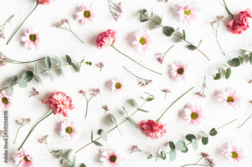 Flowers composition. Pattern made of pink flowers and eucalyptus branches on white background. Valentines day, mothers day, womens day concept. Flat lay, top view