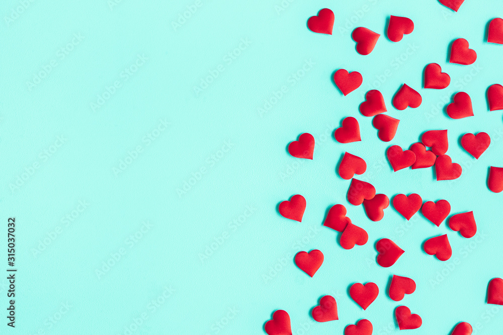 Valentine's Day background. Red hearts on pastel blue background. Valentines day concept. Flat lay, top view, copy space