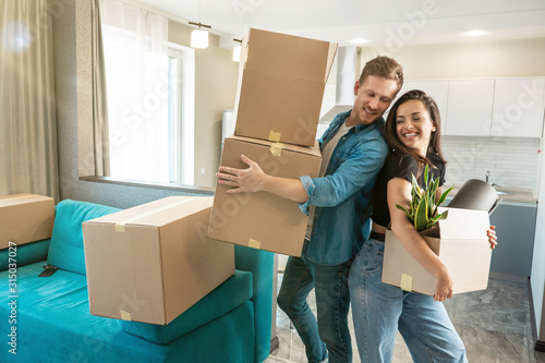 Photography young couple husband and wife looking happy standing with boxes in their hands l