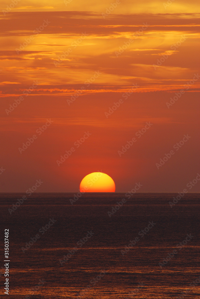 Nature landscape of Tranquil scene red sun and  red sky sunset over the sea at phuket Thailand.- Red Orange Nature Backdrops Texture 