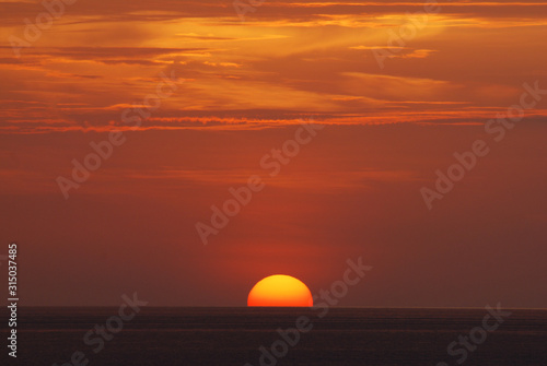 Nature landscape of Tranquil scene red sun and  red sky sunset over the sea at phuket Thailand.- Red Orange Nature Backdrops Texture  © kittinit