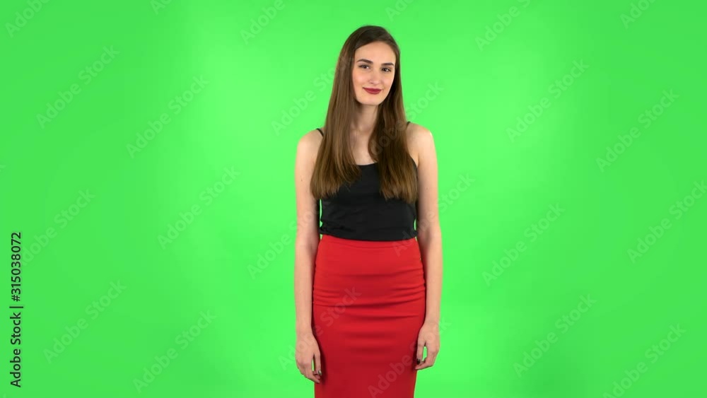 Lovely girl smiles broadly and winks flirting. Green screen Lovely girl smiles broadly and winks flirting. Green screen