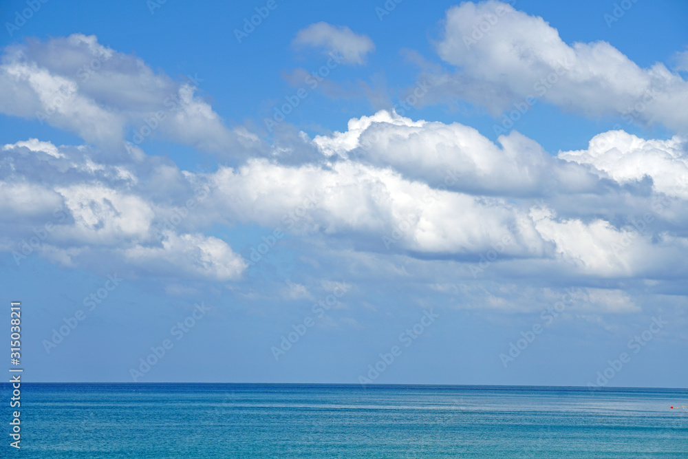 Fototapeta premium Nature seascape of Clouds blue sky and blue sea at Mai Khao beach near Phuket airport thailand - Blue nature backdrop background with copy space text