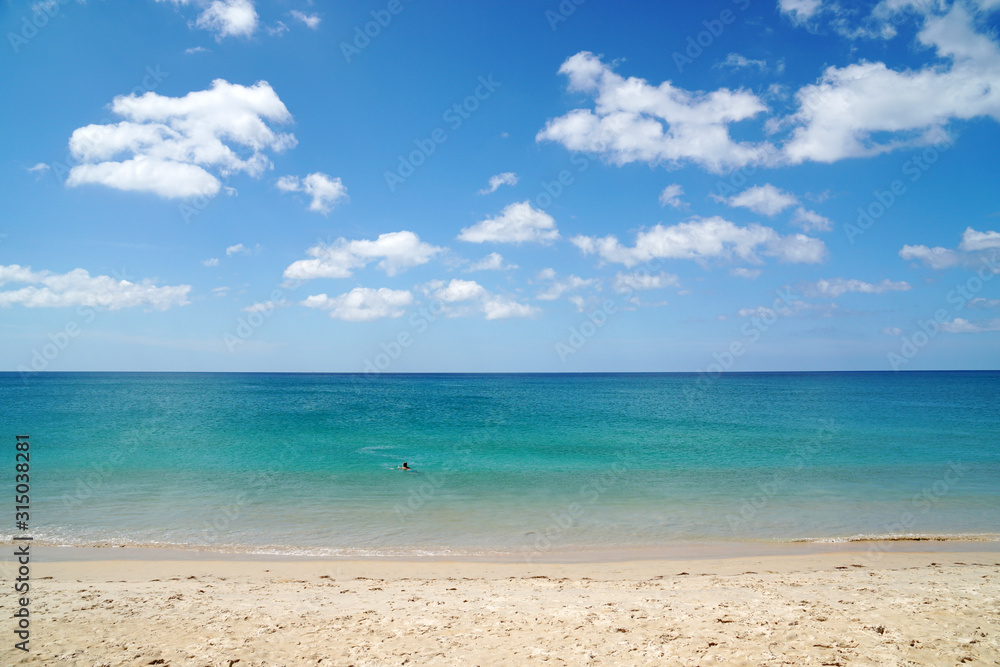 Nature seascape of Clouds blue sky and blue sea at Mai Khao beach near Phuket airport thailand - Blue nature backdrop background with copy space text Nature seascape of Clouds blue sky and blue sea at Mai Khao beach near Phuket airport thailand - Blue nature backdrop background with copy space text