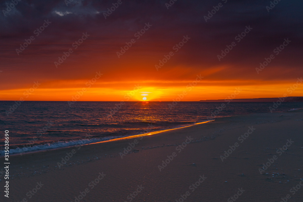 Stormy sunset over the Caspian sea coast. background of a beautiful orange-red sunset on the Caspian sea . selective focus