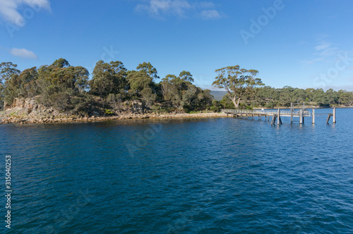 Small island with wooden jetty. Isle of the dead, Tasmania