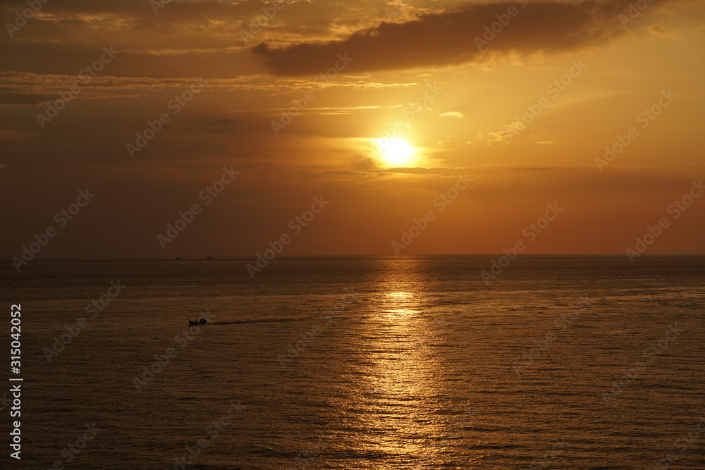 Nature seascape of Tranquil sunset scene. Sun and dark clouds with twilight sky over the sea at phuket Thailand - image backdrop background and copy space                           