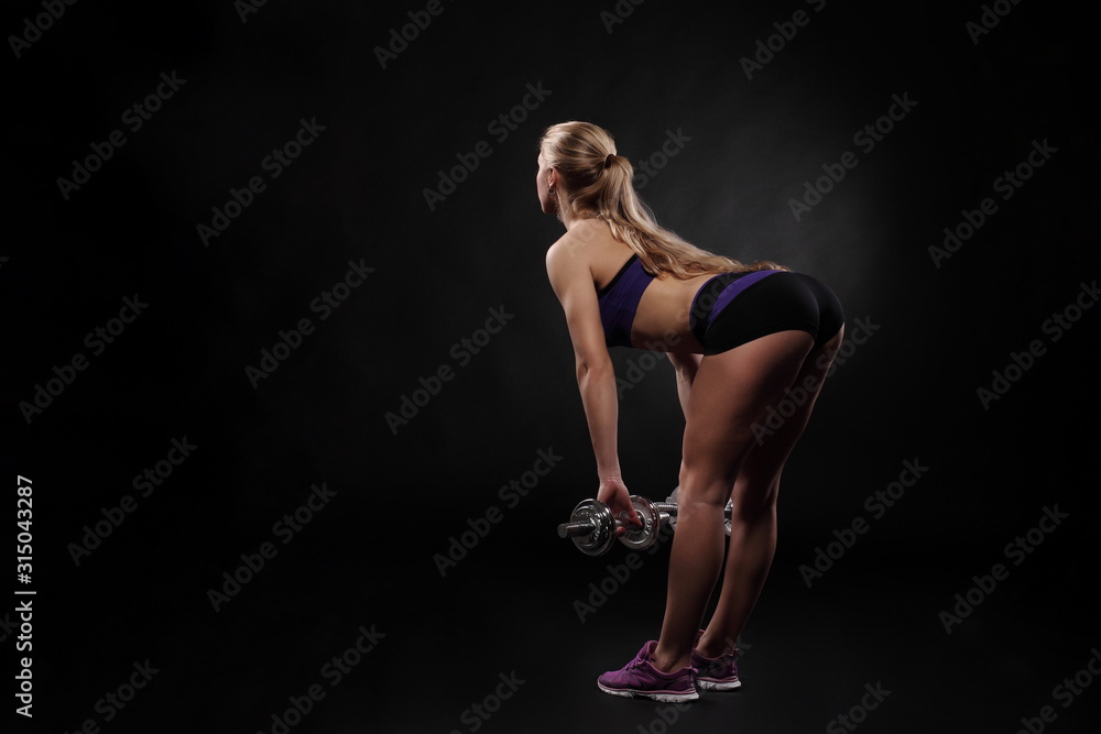 Athletic young woman doing workout with weights Athletic young woman doing workout with weights