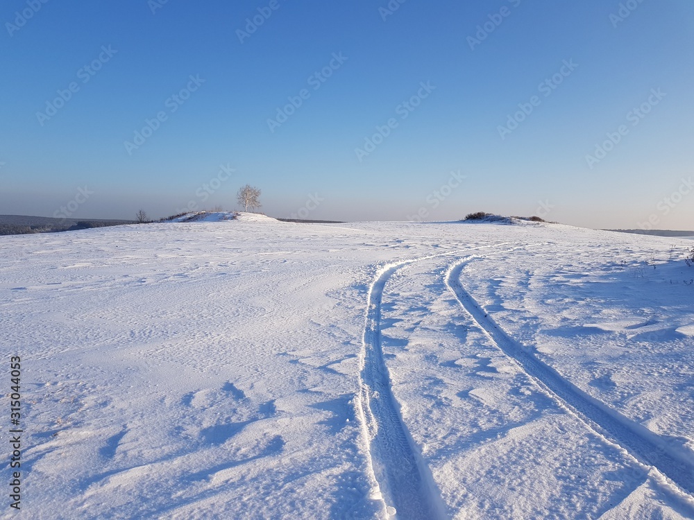 Snowy road in winter field