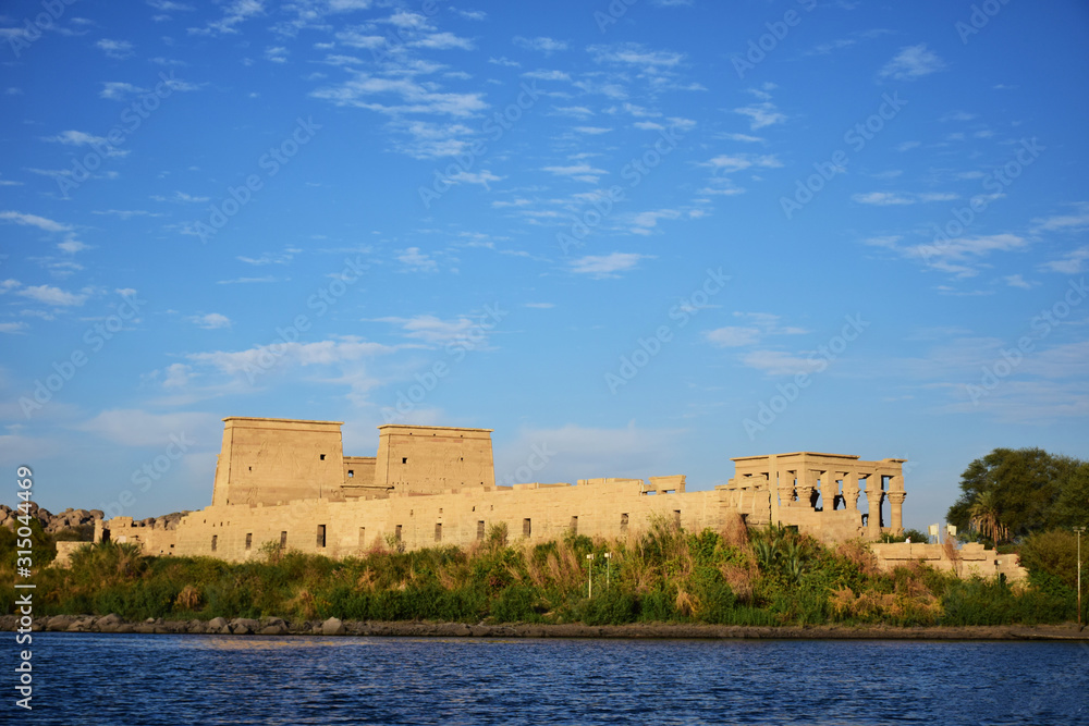 Ancient pharaohs Philae temple in Aswan Egypt in the river nile , old temple have hieroglyphs craved in its stones/Trajan's Kiosk / obelisk , Ancient Egypt Monuments Ancient pharaohs Philae temple in Aswan Egypt in the river nile , old temple have hieroglyphs craved in its stones/Trajan's Kiosk / obelisk , Ancient Egypt Monuments