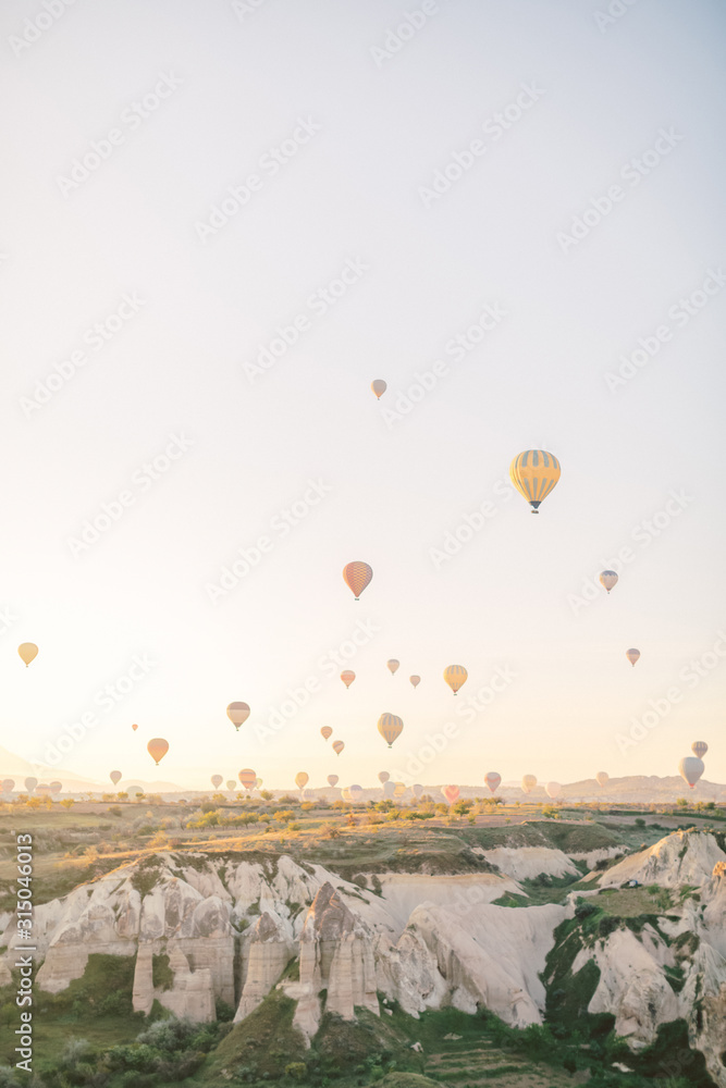 Colorful hot air balloons flying over the valley in Cappadocia, Turkey