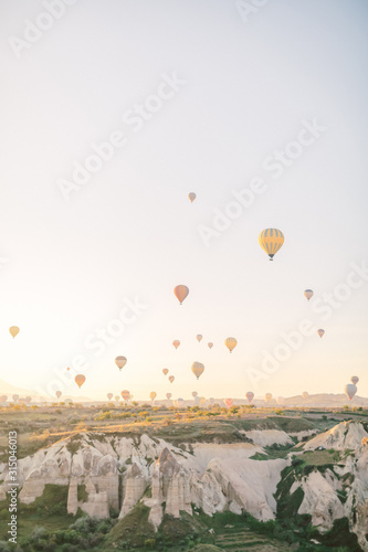 Colorful hot air balloons flying over the valley in Cappadocia, Turkey