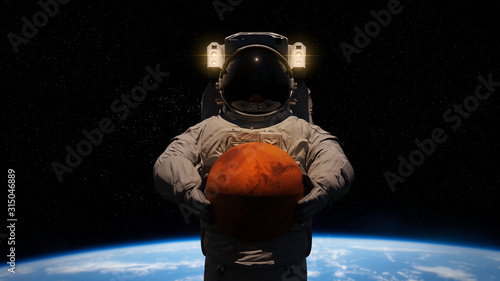 Fototapeta Naklejka Na Ścianę i Meble -  astronaut holding planet Mars in front of the Earth 