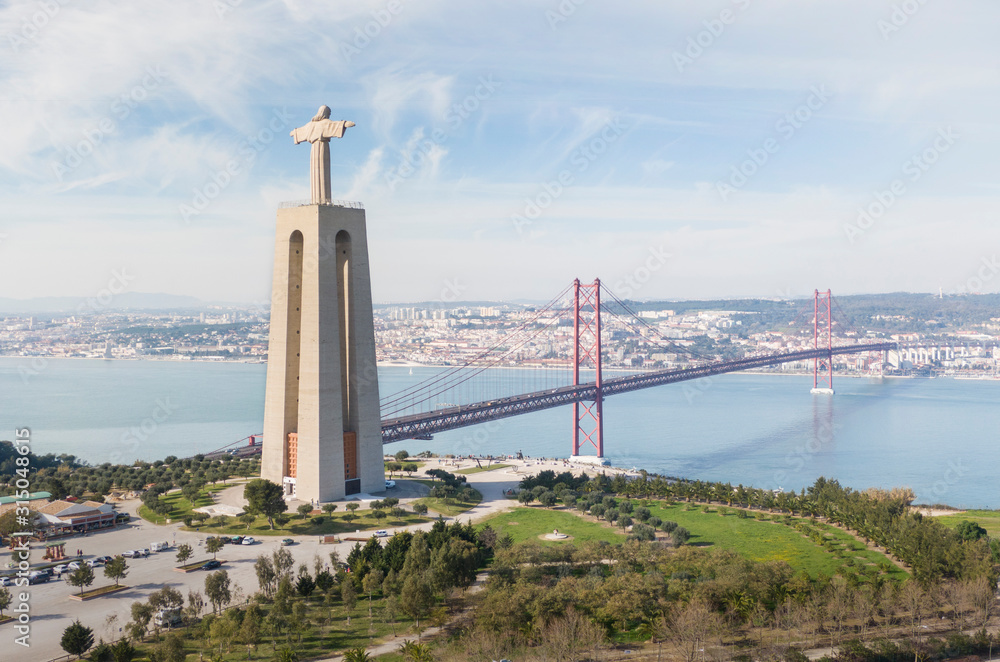 Aerial view of Cristo Rei (The Sanctuary of Christ the King) and the 25 de Abril Bridge (25th of April Bridge), Lisbon, Portugal