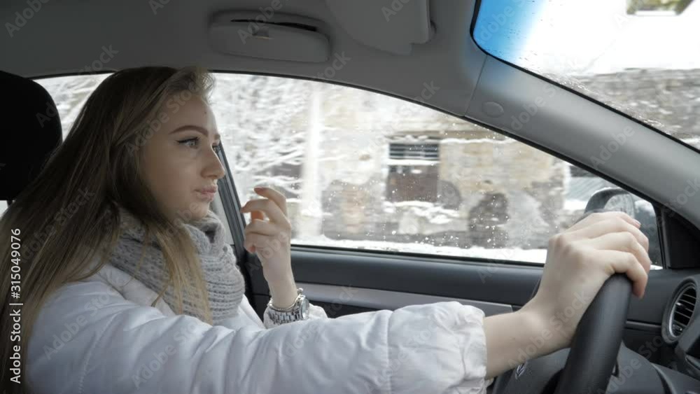 Young blond girl is driving car. Winter Young blond girl is driving car. Winter