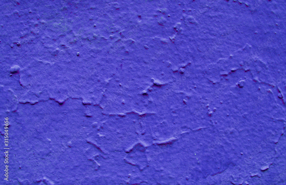 Uneven structure of blue paint on stucco.