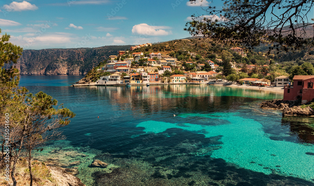Wonderful summer seascape of Ionian Sea. Wonderful place for holiday. Amazing Greece. Picturesque colorful village Assos in Kefalonia. Turquoise colored bay in Mediterranean sea. Amazing postcard