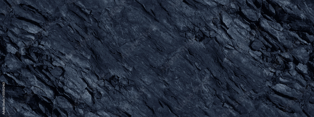 Monochrome mountain texture. Toned stone background. Dark blue rock background. Gray blue grunge banner.