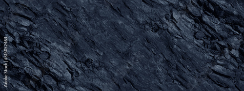 Monochrome mountain texture. Toned stone background. Dark blue rock background. Gray blue grunge banner.