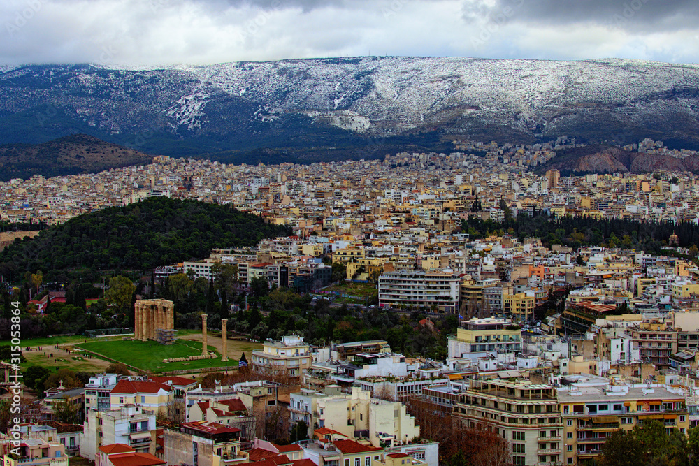 Amazing aerial view over the city of Athens against cloudy sky. Famous touristic place and travel destination in Europe. Greece